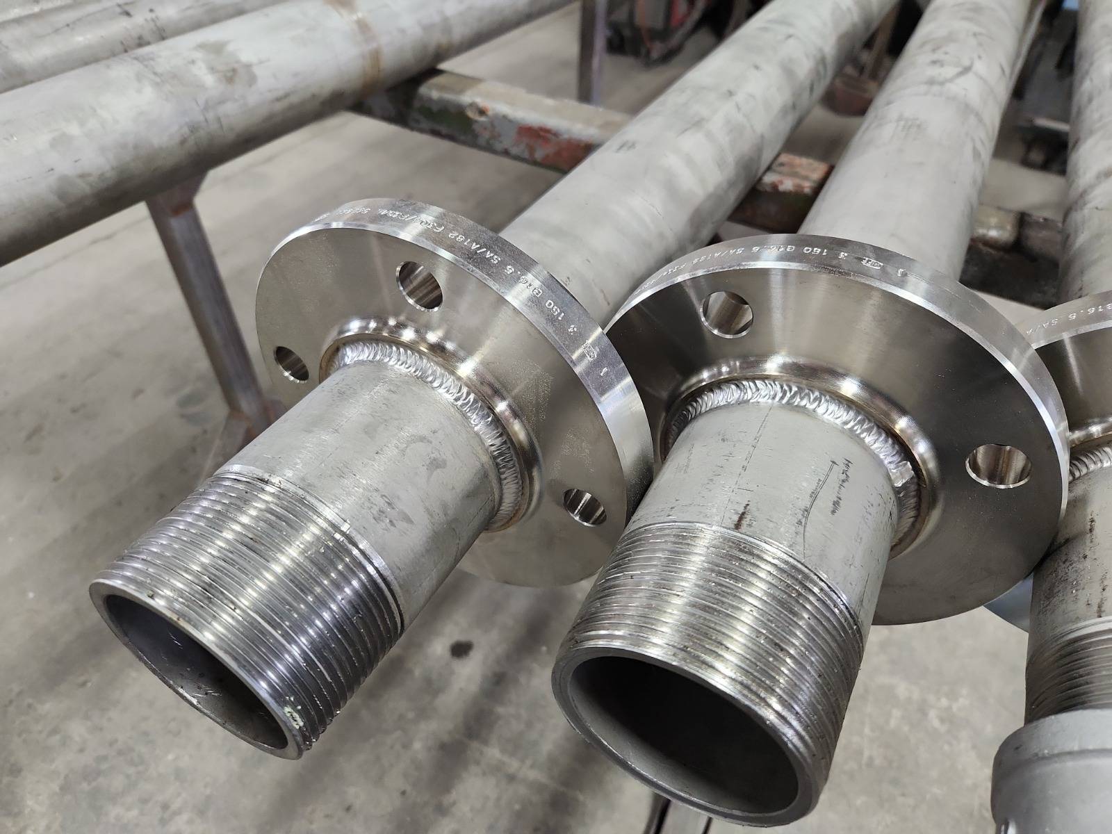 Machined flanges welded to threaded steel pipe