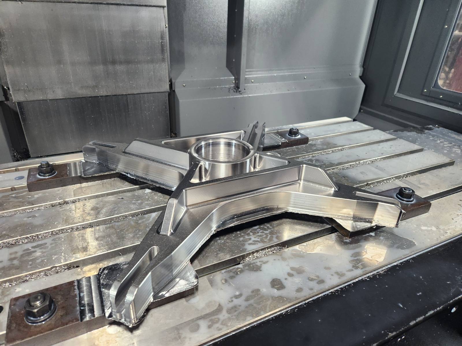 Fixtured machined bracket with a bored center hub